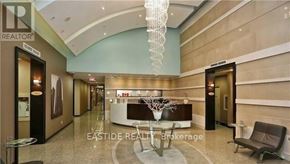 Toronto (Willowdale East) condo for rent - A reception area with a table and chairs and a sign that says "EASTIDE REALTOR Brokerage".