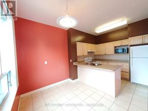Toronto (Willowdale East) condo for rent - A kitchen with red walls and white appliances.