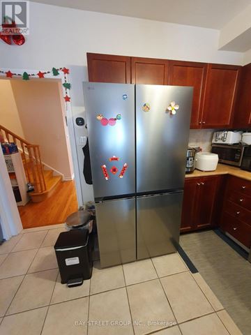 Markham (Village Green-South Unionville) apartment for rent - A stainless steel refrigerator with magnets and magnets on it in a kitchen.