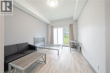 Hamilton condo for rent - A living room with a grey couch and a wooden coffee table.