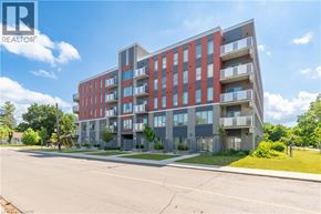 Hamilton condo for rent - A modern multi-story apartment building with balconies and a clear blue sky above.