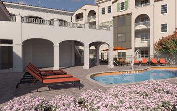 Roseville townhouse for rent - A pool area with a bench and flowers in front of a building.
