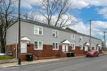 Louisville apartment for rent - A row of houses with a red car parked in front of the first house.