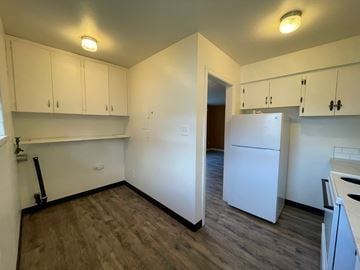Longview apartment for rent - A kitchen with white cabinets and a white fridge.