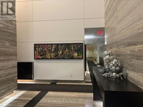 Toronto (Church-Yonge Corridor) condo for rent - A hallway with a large painting on the wall and a sign that says "EXIT".