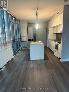 Toronto (Church-Yonge Corridor) condo for rent - A kitchen with white appliances and a wooden floor.