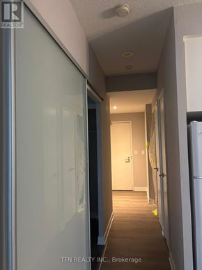 Toronto (Church-Yonge Corridor) condo for rent - A hallway with a glass door on the left and a white door on the right.