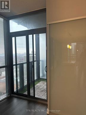 Toronto (Church-Yonge Corridor) condo for rent - A glass door with a handle is open to a balcony.