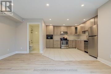 Brampton (Bram West) apartment for rent - A kitchen with wooden cabinets and stainless steel appliances.