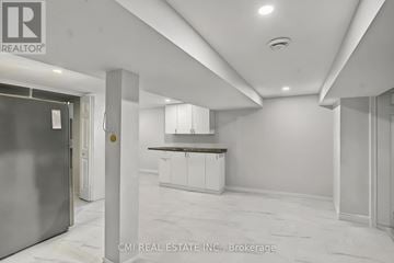 Niagara Falls (Dorchester) apartment for rent - A spacious kitchen area with white cabinets and a marble floor.