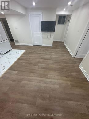 Bradford West Gwillimbury (Bradford) apartment for rent - A room with a wooden floor and a white door.