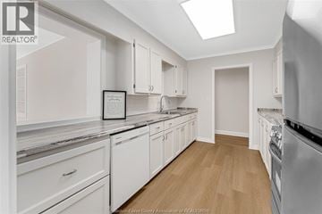 Kingsville apartment for rent - A white kitchen with a fridge, oven and a skylight.