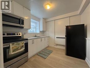Kitchener apartment for rent - A kitchen with a black fridge, stove and microwave.