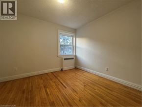 Kitchener apartment for rent - A room with wooden floors and a window with a white frame.