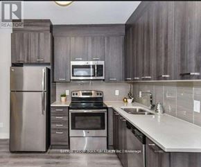 Hamilton (Central) condo for rent - A modern kitchen with a stainless steel refrigerator and oven.