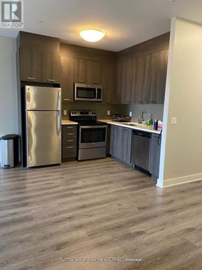 Hamilton (Central) condo for rent - A kitchen with a refrigerator, oven, and microwave.