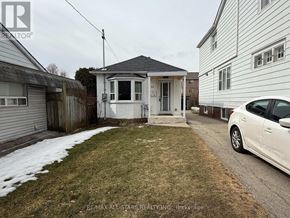Toronto (Long Branch) apartment for rent - A white car is parked on a driveway in front of a house.