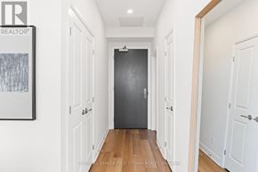 Ottawa condo for rent - A hallway with white doors and a black door at the end.