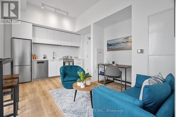 Toronto (Mount Pleasant West) condo for rent - A modern living room with a blue couch and a coffee table.