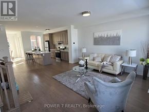 Markham townhouse for rent - A living room with a grey couch and a coffee table in the middle.