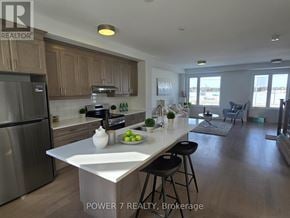 Markham townhouse for rent - A modern kitchen with wooden cabinets and a large island.