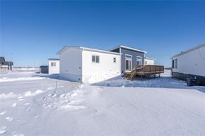 Mitchell apartment for rent - A white house with a snow-covered ground in front of it.