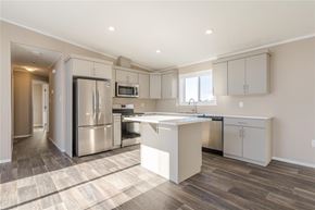 Mitchell apartment for rent - A kitchen with a refrigerator, microwave, and oven.