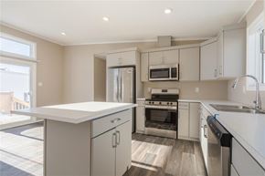 Mitchell apartment for rent - A modern kitchen with a white countertop and stainless steel appliances.