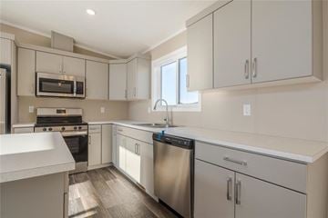 Mitchell apartment for rent - A kitchen with white cabinets and stainless steel appliances.