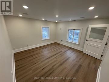 Mississauga (Streetsville) apartment for rent - A kitchen with white cabinets and black appliances.