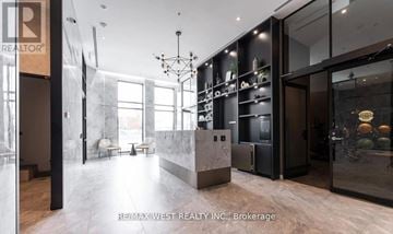 Oakville (Wm Westmount) condo for rent - A modern kitchen with a marble countertop and a refrigerator with a glass door.