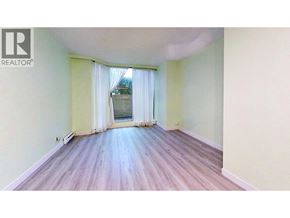 Vancouver apartment for rent - A room with wooden flooring and a window with curtains.