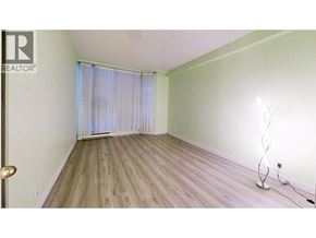 Vancouver apartment for rent - A room with a wooden floor and a window with curtains.