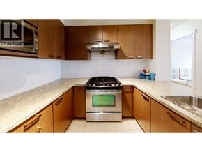 Richmond apartment for rent - A kitchen with a stove top oven and wooden cabinets.
