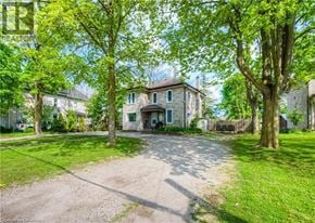 Cambridge apartment for rent - A house with a driveway and trees in front.