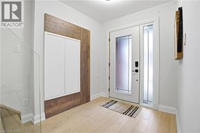 Hamilton apartment for rent - A hallway with a white door and a brown wood panel.