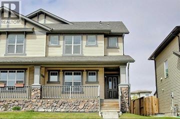 Calgary apartment for rent - A house with a stone wall and a black door.