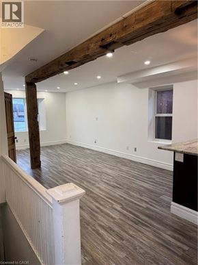 Hamilton apartment for rent - A room with wooden beams on the ceiling and a window on the wall.
