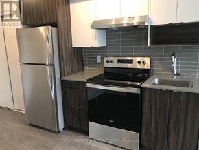 Burlington (Lasalle) condo for rent - A modern kitchen with a stainless steel refrigerator, oven, and sink.