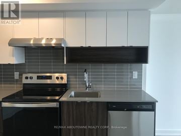 Burlington (Lasalle) condo for rent - A modern kitchen with a stove top oven and a dishwasher.