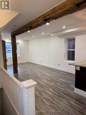 Hamilton (Crown Point) apartment for rent - A room with wooden beams on the ceiling and a window on the wall.