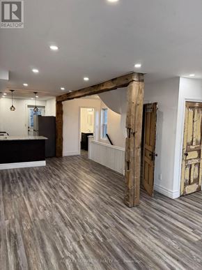 Hamilton (Crown Point) apartment for rent - A room with wooden floors and a large wooden beam on the wall.