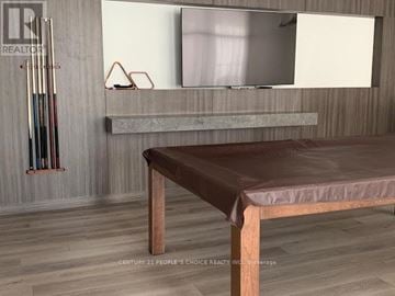 Toronto (Weston-Pellam Park) condo for rent - A modern living room with a brown leather sofa and a grey countertop.