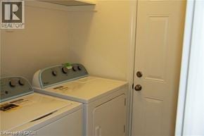 St. Catharines townhouse for rent - A small laundry room with a washer and dryer.