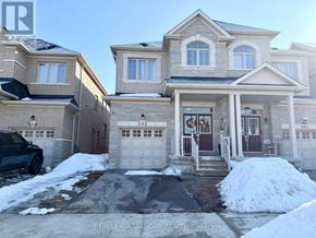 Markham (Cedarwood) apartment for rent - A large house with a garage and a driveway in front of it.