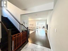Markham (Cedarwood) apartment for rent - A spacious hallway with a staircase and a living room in the background.