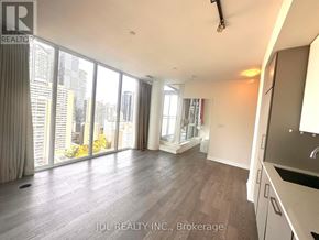 Toronto (Church-Yonge Corridor) condo for rent - A spacious living room with a view of the cityscape outside the large windows.