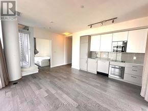 Toronto (Church-Yonge Corridor) condo for rent - A spacious kitchen with white cabinets and a grey floor.