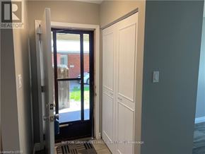 London North (North F) multi-family for rent - A doorway with a glass door leading to a balcony.