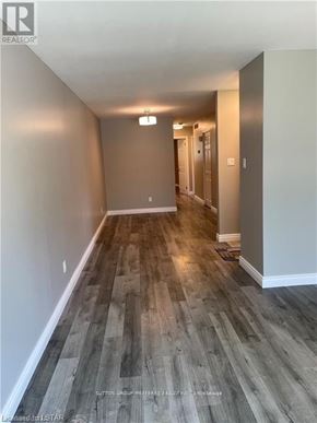 London North (North F) multi-family for rent - A long hallway with wood flooring and white walls.